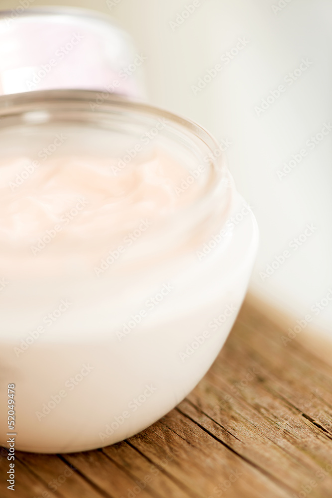 Cosmetic cream in jar close up on wooden surface Cosmetic cream in jar close up on wooden surface