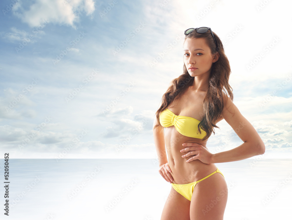 Stock photo of young, fit and sexy woman in yellow swimsuit Stock photo of young, fit and sexy woman in yellow swimsuit