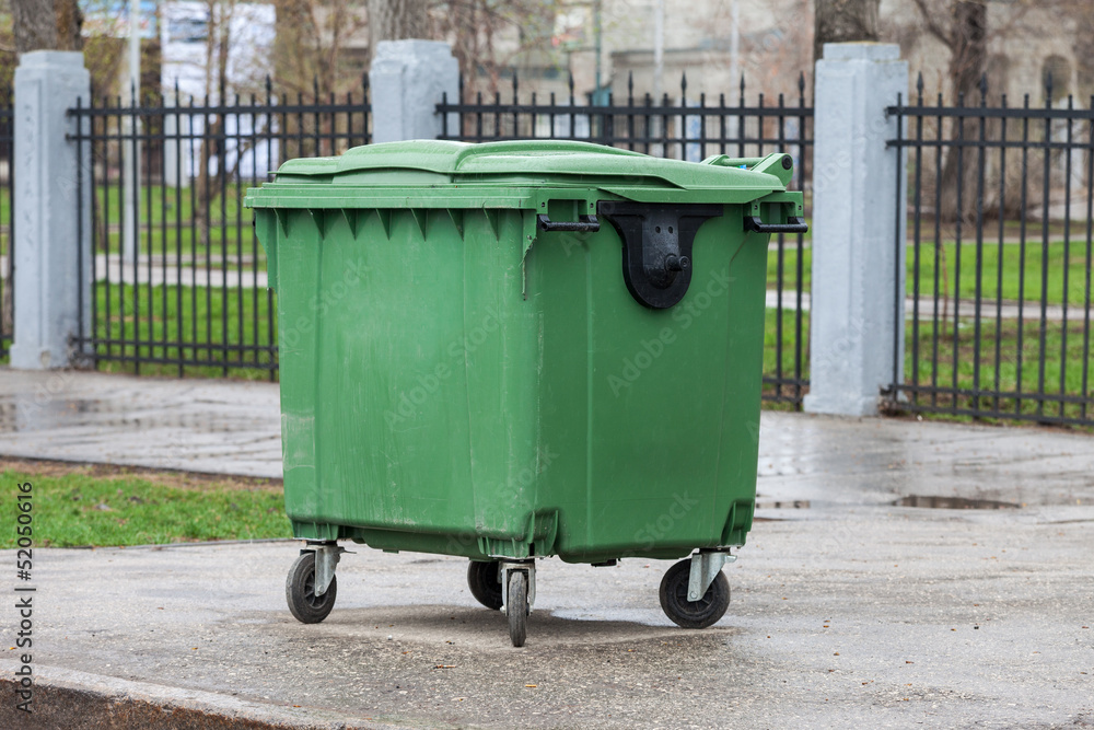 Green recycling container on the street of city Green recycling container on the street of city