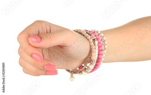 Female hand with pink manicure and bright bracelet, isolated