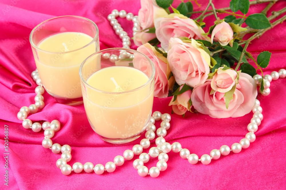 Candle on pink fabric close -up Candle on pink fabric close -up