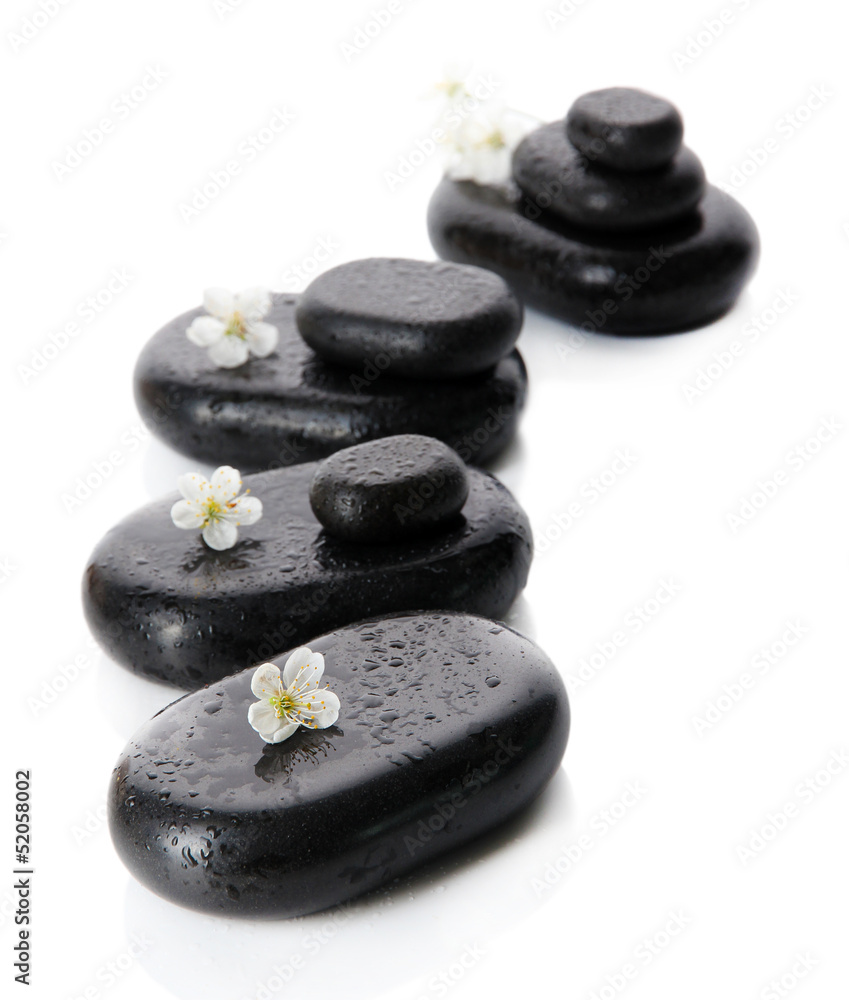 Spa stones and white flowers isolated on white