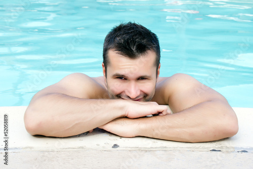 Smiling attractive man at the swimming pool