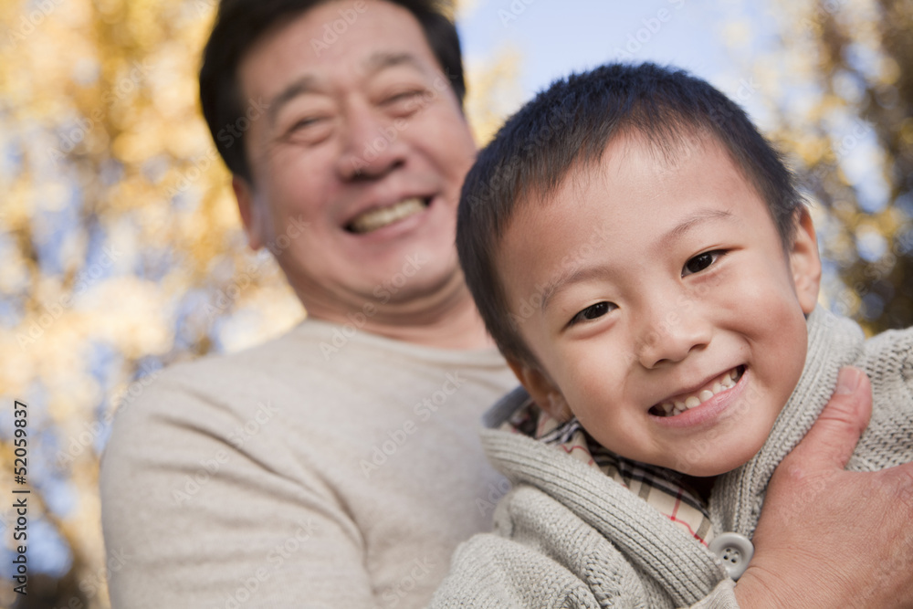 Grandfather and Grandson Enjoying in the Park Grandfather and Grandson Enjoying in the Park