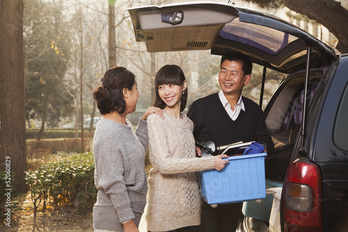 Family unpacking minivan for college, Beijing photo