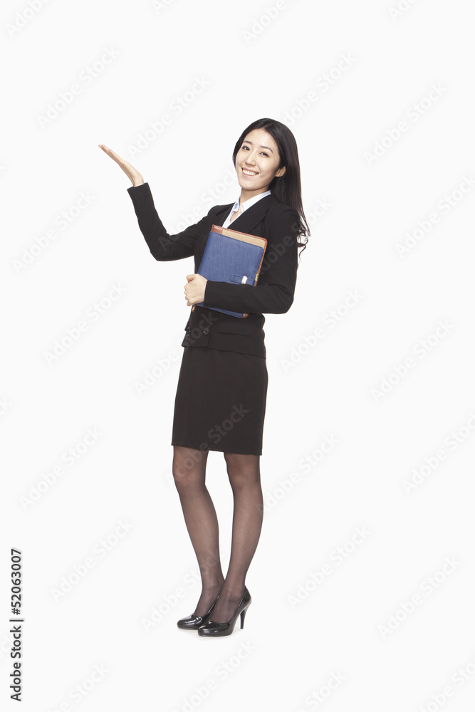 Businesswoman carrying files with raised hand Businesswoman carrying files with raised hand