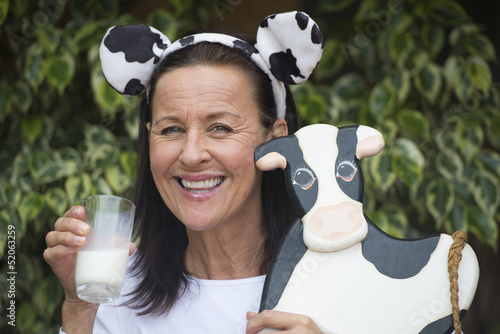 Friendly mature woman with milksop and cow photo