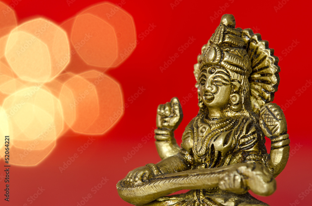close up of a hindu deity statue on red background