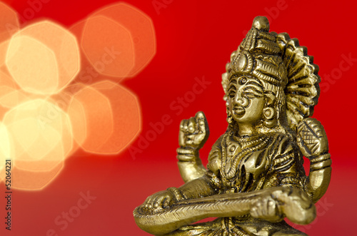 close up of a hindu deity statue on red background