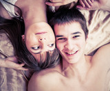 Young happy couple in bed