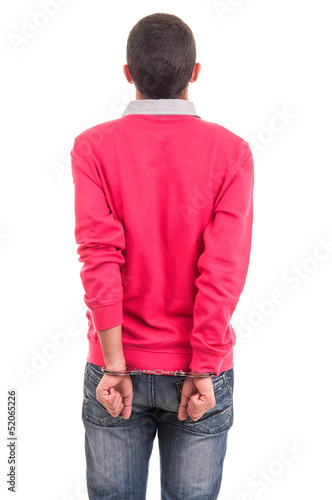 young man handcuffed with hands behind his back