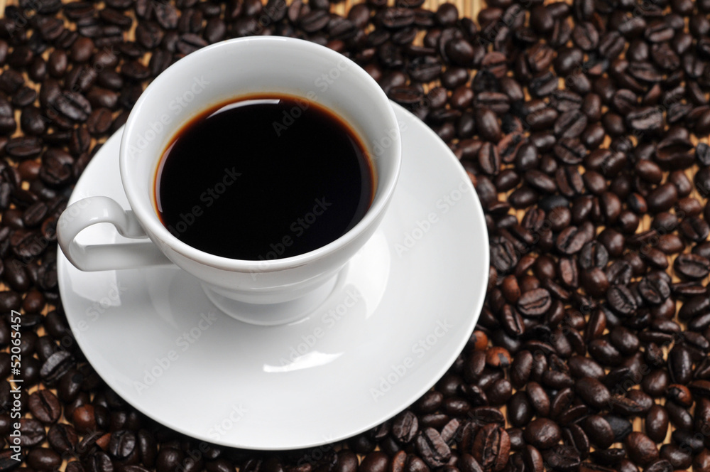Cup of coffee on coffee beans background Cup of coffee on coffee beans background