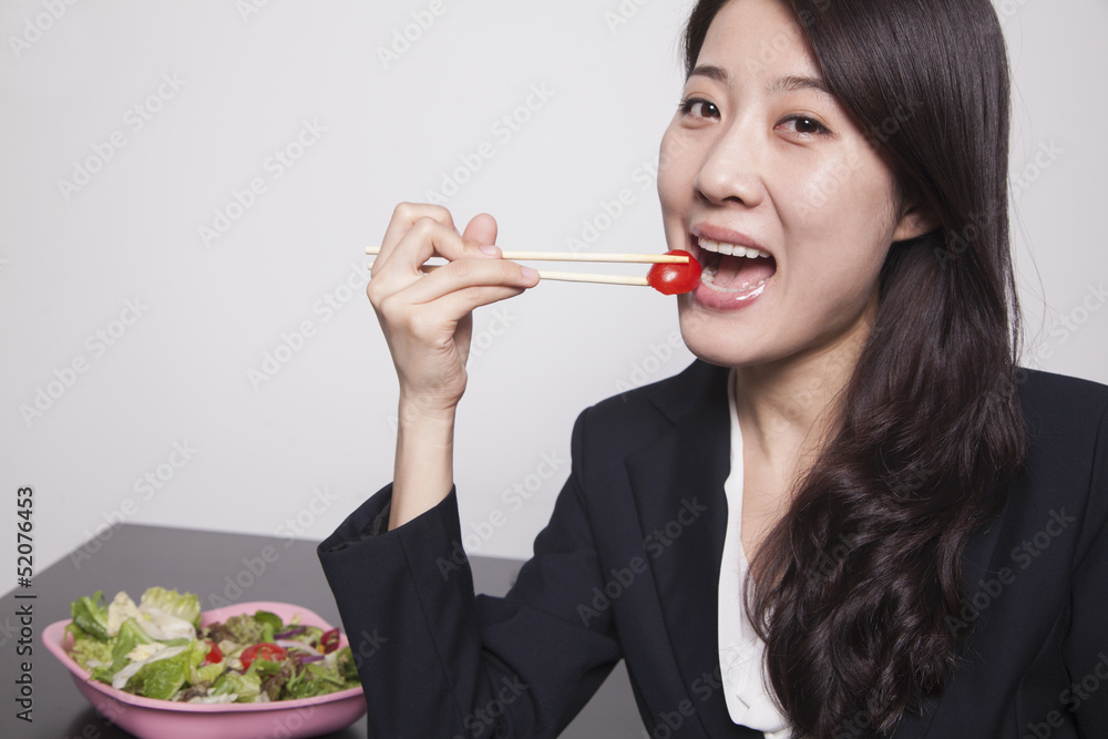 Young businesswoman enjoying a salad, portrait Young businesswoman enjoying a salad, portrait