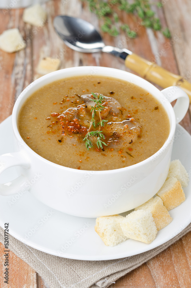 Mushroom cream soup with croutons and thyme in a bowl vertical Mushroom cream soup with croutons and thyme in a bowl vertical