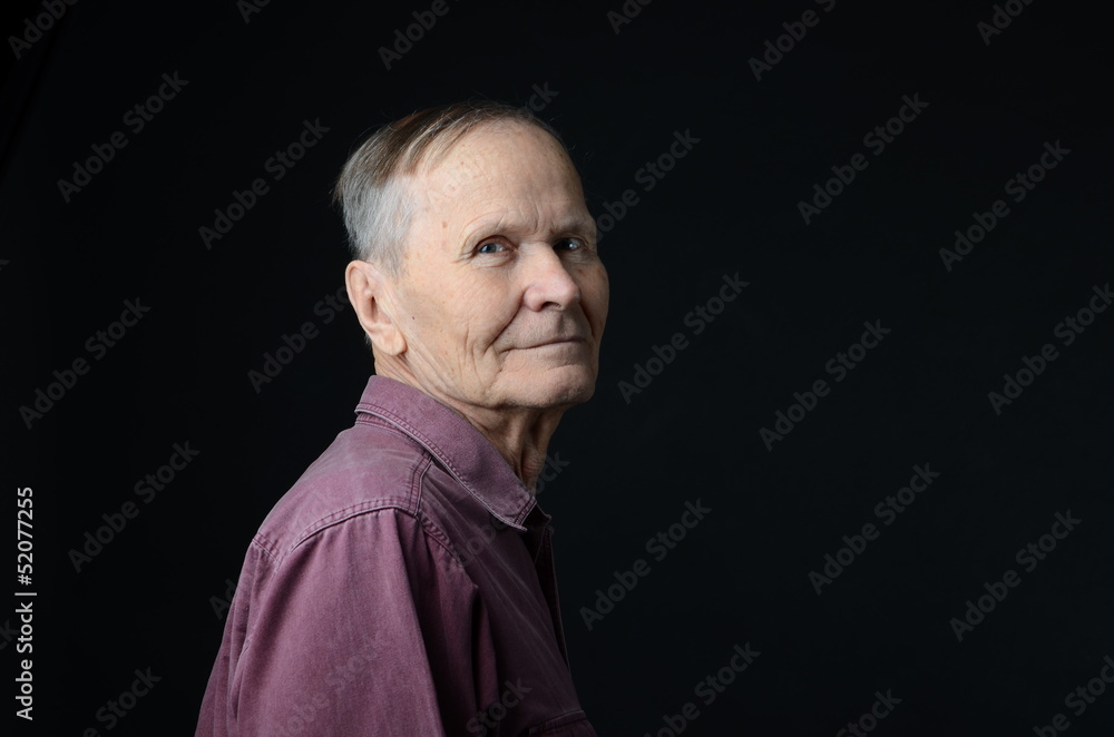 Obraz premium senior looking at camera on black background