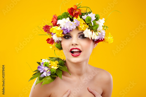 The attractive girl, front portrait, on a head a flower wreath