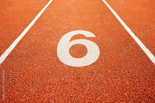 number six on running track photo