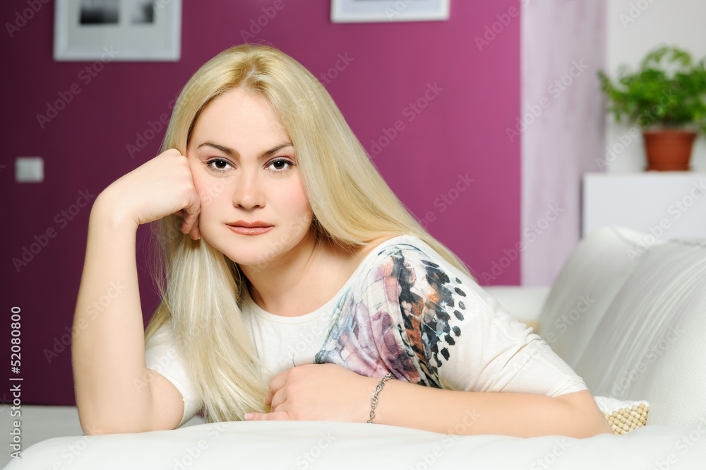 Naklejka premium portrait of beautiful blond girl at home