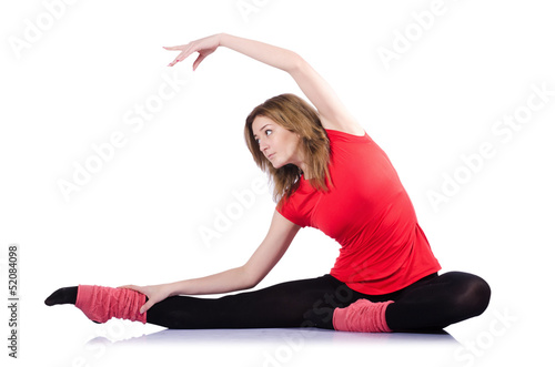 Young gymnast exercising on white