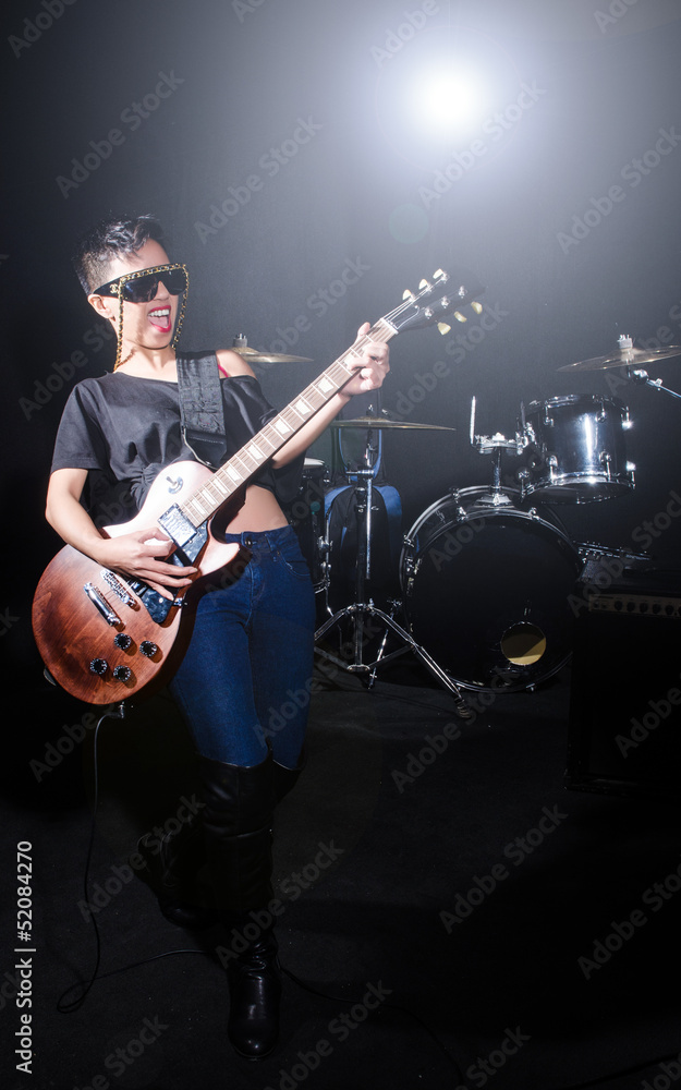 Woman guitar player during concert Woman guitar player during concert
