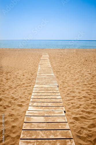 Wooden path to the sandy beach