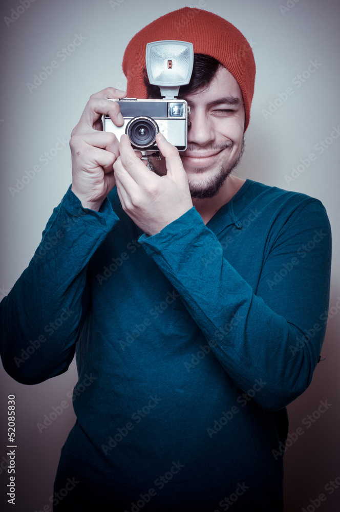 Fototapeta premium young stylish man holding old camera