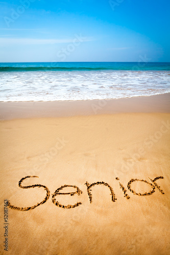 Word Senior Written in Sand, on Tropical Beach