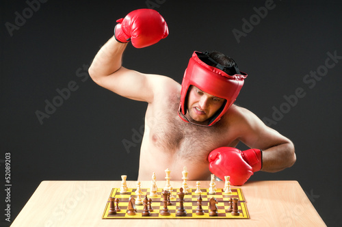 Boxer stuggling with chess game photo