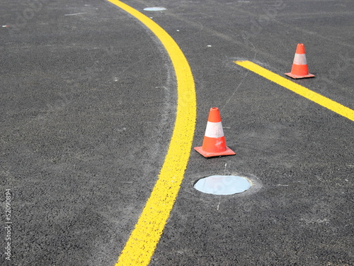 Yellow stripes with traffic cone
