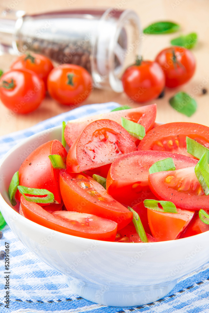 Salad from fresh tomatoes, spring green onions and black pepper Salad from fresh tomatoes, spring green onions and black pepper