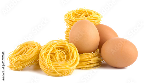 Eggs and pasta nest isolated on white background