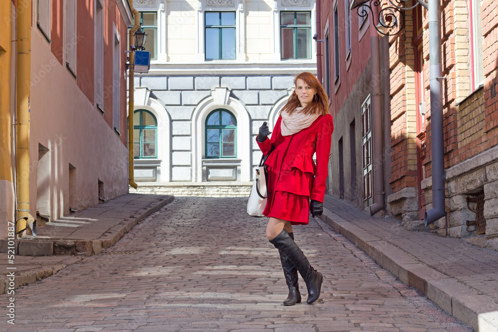 young attractive woman walking in old town of Tallinn