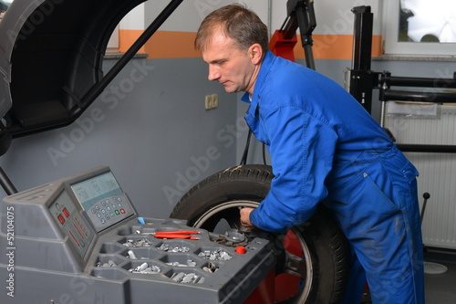 Slika na platnu Wheel Balancing, Auto mechanic spins a car wheel