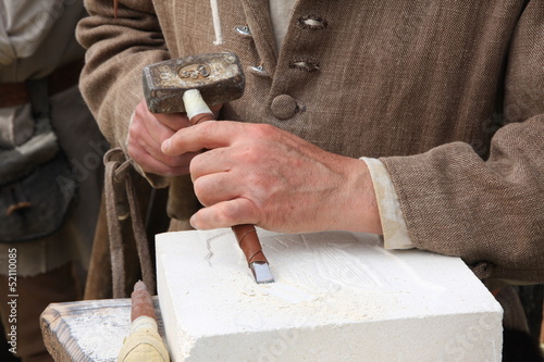 Принти на полотні old craftsman Mason during the processing of a piece of white ma