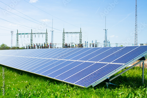 solar panel against high voltage towers photo