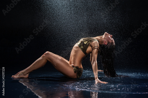 Woman under rain. Studio photo