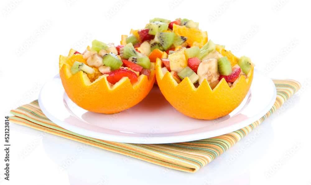 Fruit salad in hollowed-out orange isolated on white