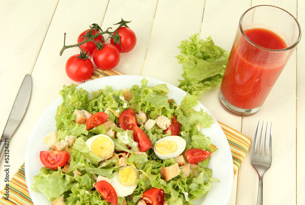 Caesar salad on blue plate, on color wooden background Caesar salad on blue plate, on color wooden background