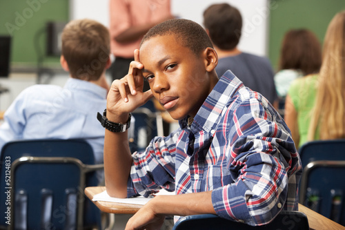 Slika na platnu Bored Male Teenage Pupil In Classroom