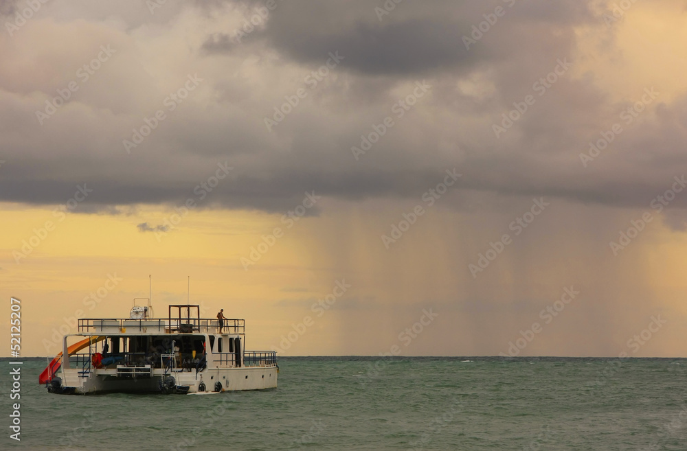 Obraz premium Rainstorm in a sea at sunrise