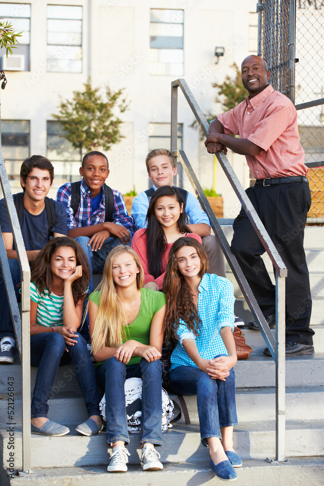 Fototapeta premium Group Of Teenage Pupils Outside Classroom With Teacher