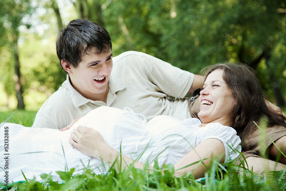 Pregnant wife and her husband laughing Pregnant wife and her husband laughing