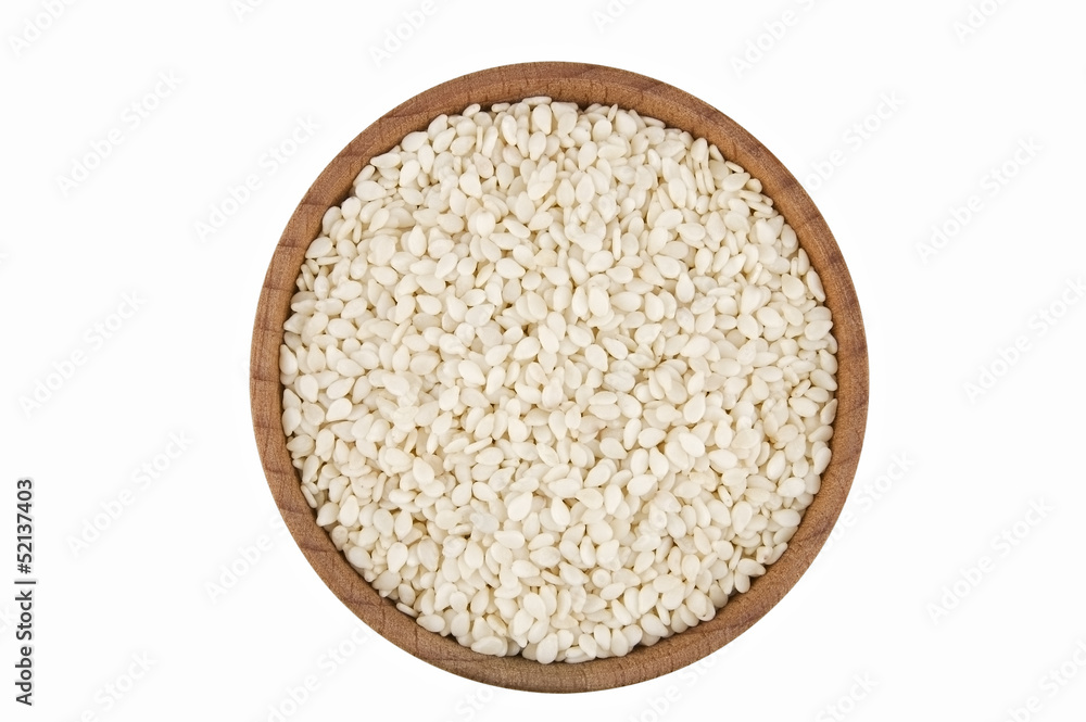 Sesame seeds in wooden bowl isolated on white Sesame seeds in wooden bowl isolated on white