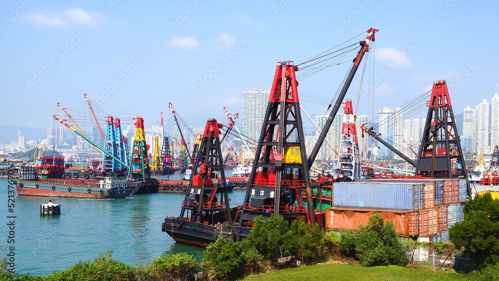 Container ship under cranes at Hong Kong port. Container ship under cranes at Hong Kong port.