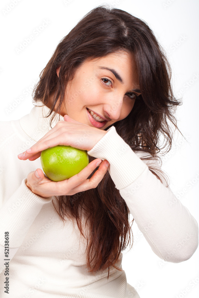 Young beautiful woman smiling with a green apple on hands Young beautiful woman smiling with a green apple on hands