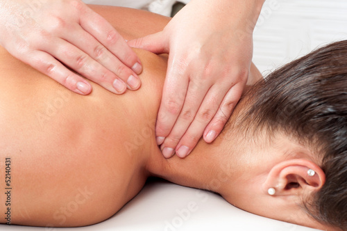 Young woman getting massage in massage salon