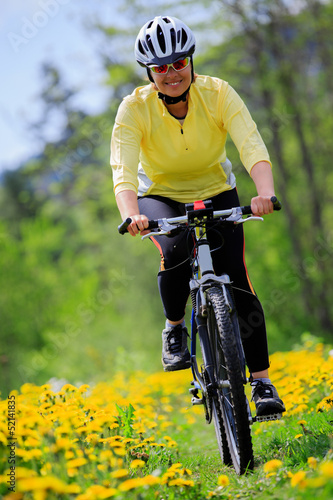 Bike riding - woman on bike, active adult concept