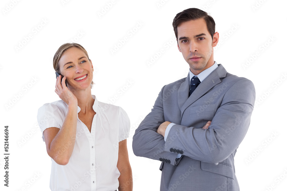 Smiling businesswoman on the phone next to her colleague Smiling businesswoman on the phone next to her colleague