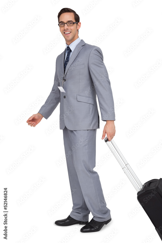 Smiling businessman walking with his suitcase Smiling businessman walking with his suitcase