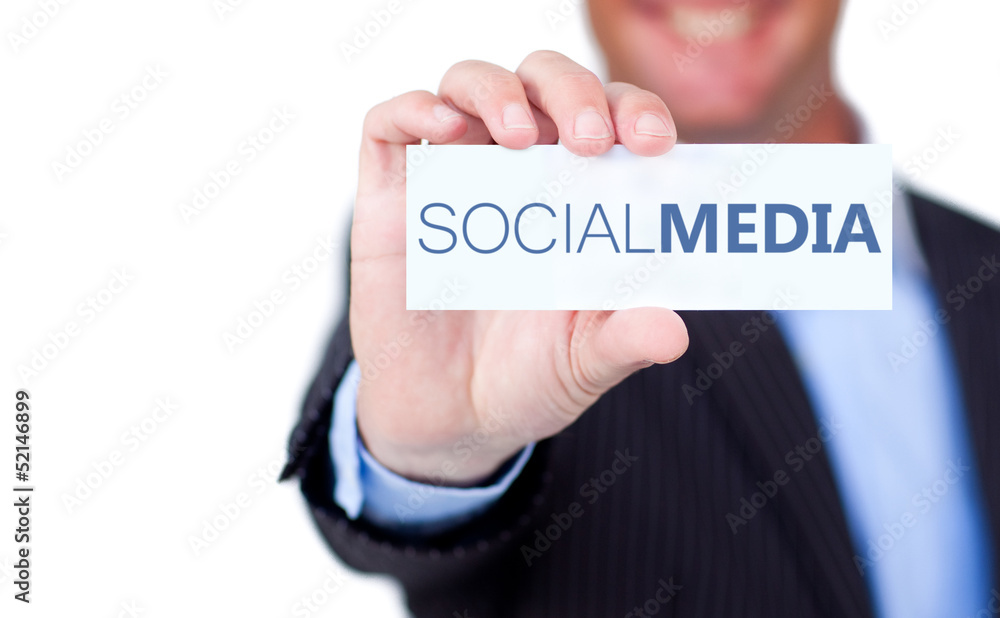 Businessman holding a label with social media written on it Businessman holding a label with social media written on it
